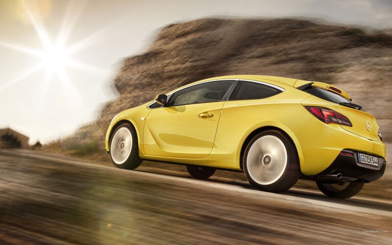 yellow sports car in motion