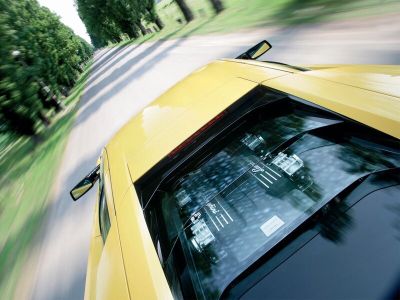yellow sports car in motion