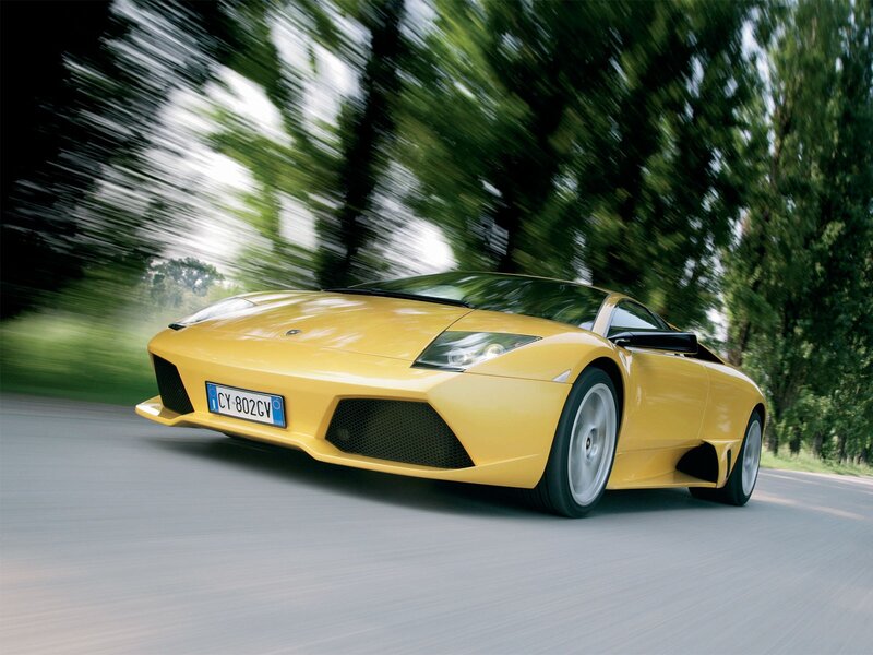yellow sports car in motion