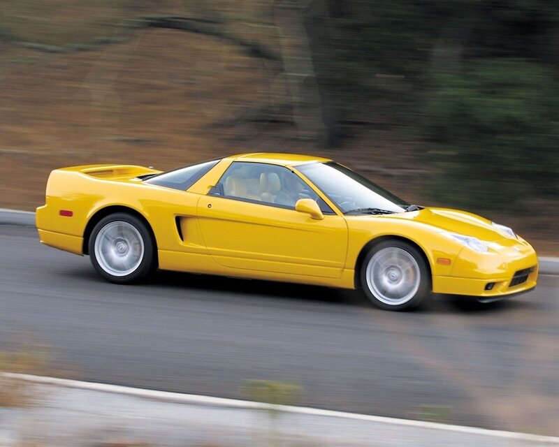yellow sports car in motion