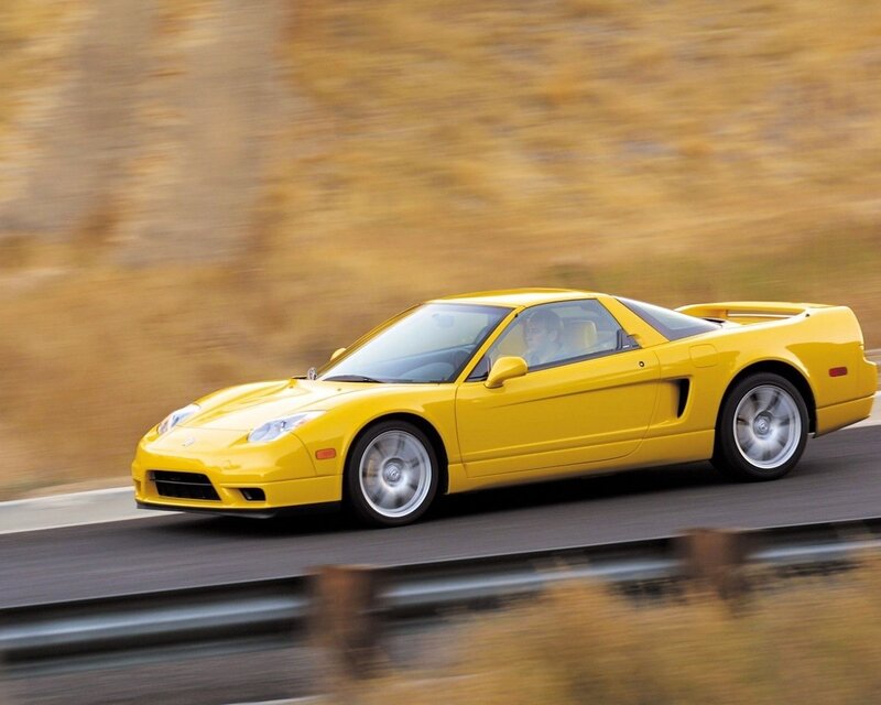 yellow sports car in motion
