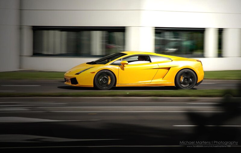 yellow sports car in motion