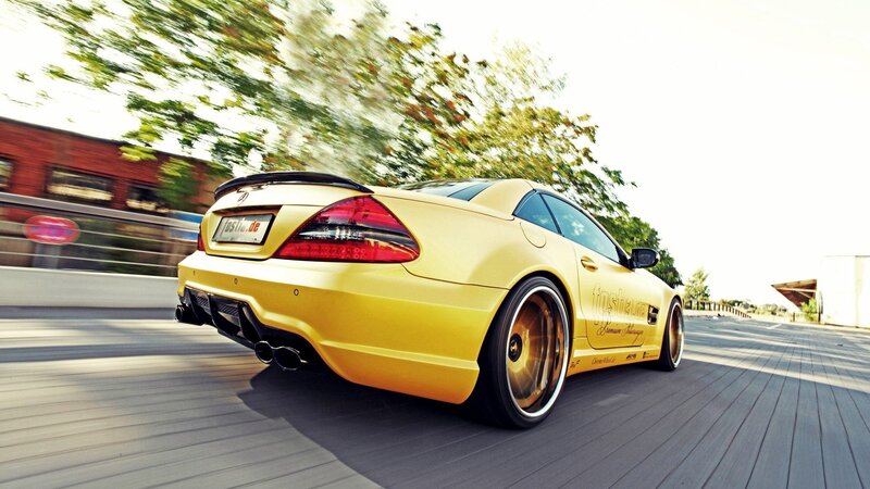 yellow sports car in motion