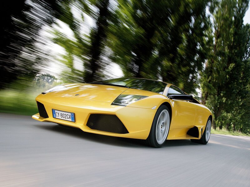 yellow sports car in motion