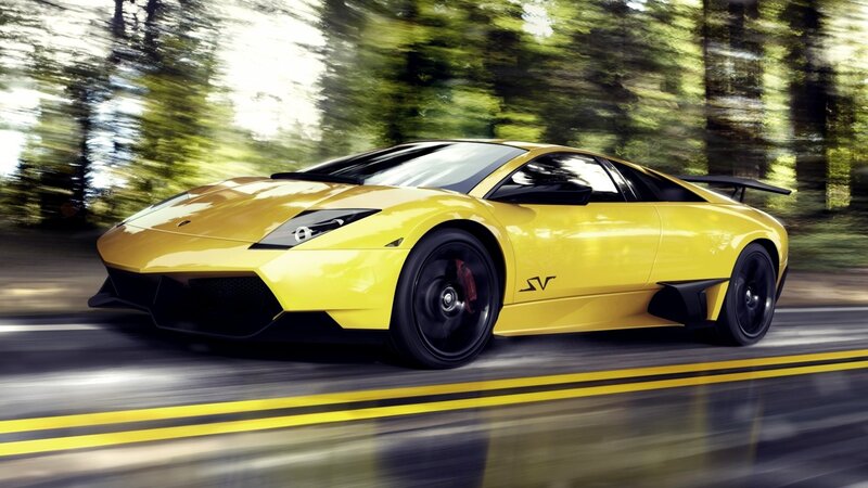 yellow sports car in motion