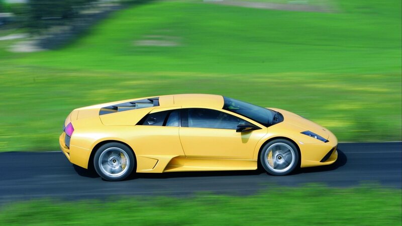 yellow sports car in motion
