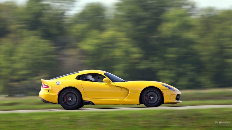 yellow sports car in motion
