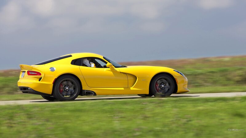yellow sports car in motion
