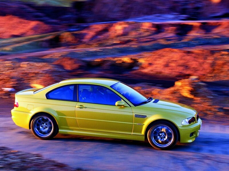 yellow sports car in motion