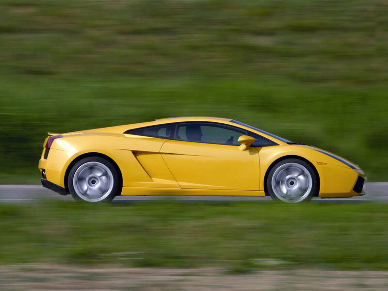 yellow sports car in motion