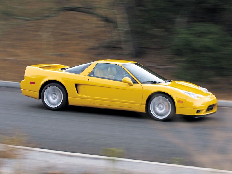 yellow sports car in motion