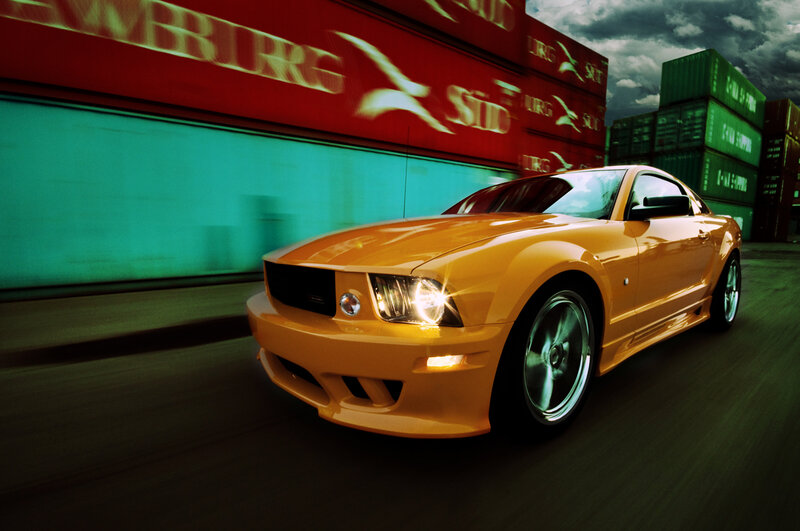 yellow sports car in motion