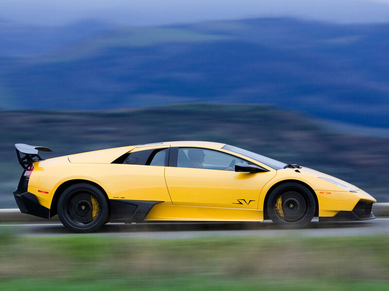 yellow sports car in motion