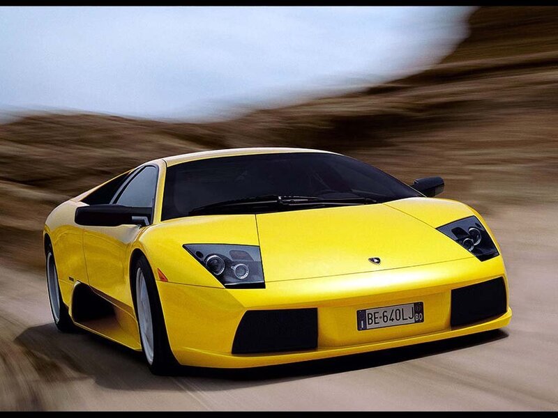 yellow sports car in motion