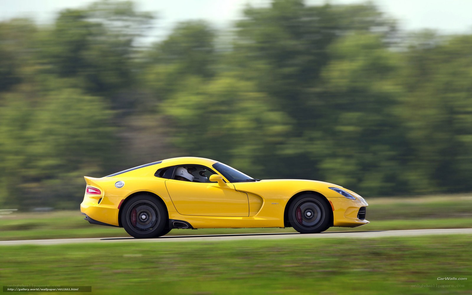 yellow sports car in motion