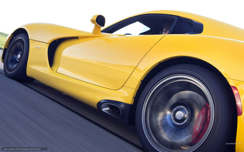 yellow sports car in motion