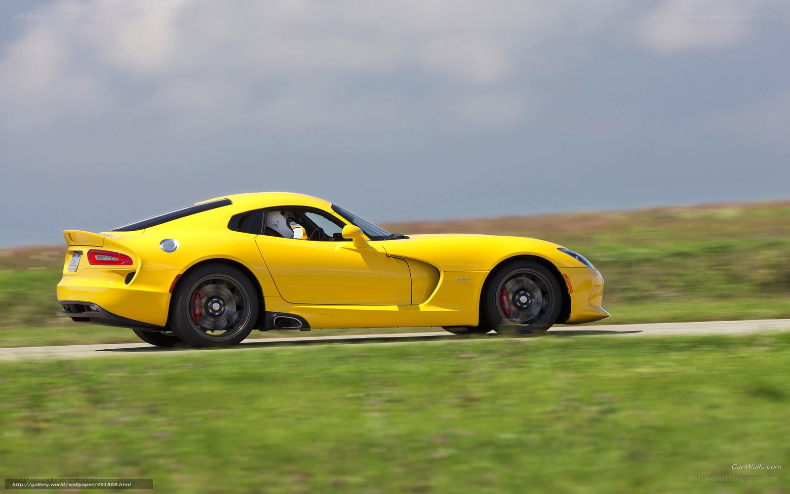 yellow sports car in motion