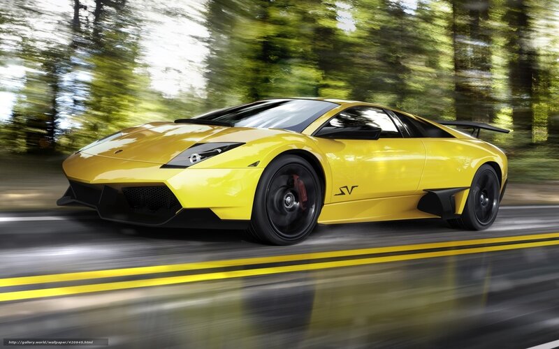 yellow sports car in motion