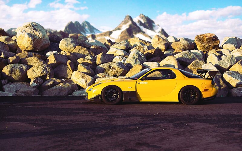 Yellow sports car in mountain landscape