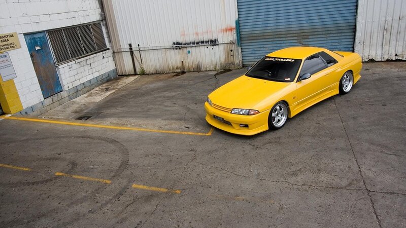 yellow sports car in parking lot