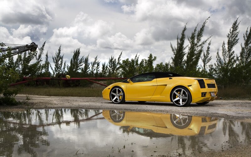 Yellow sports car in puddle