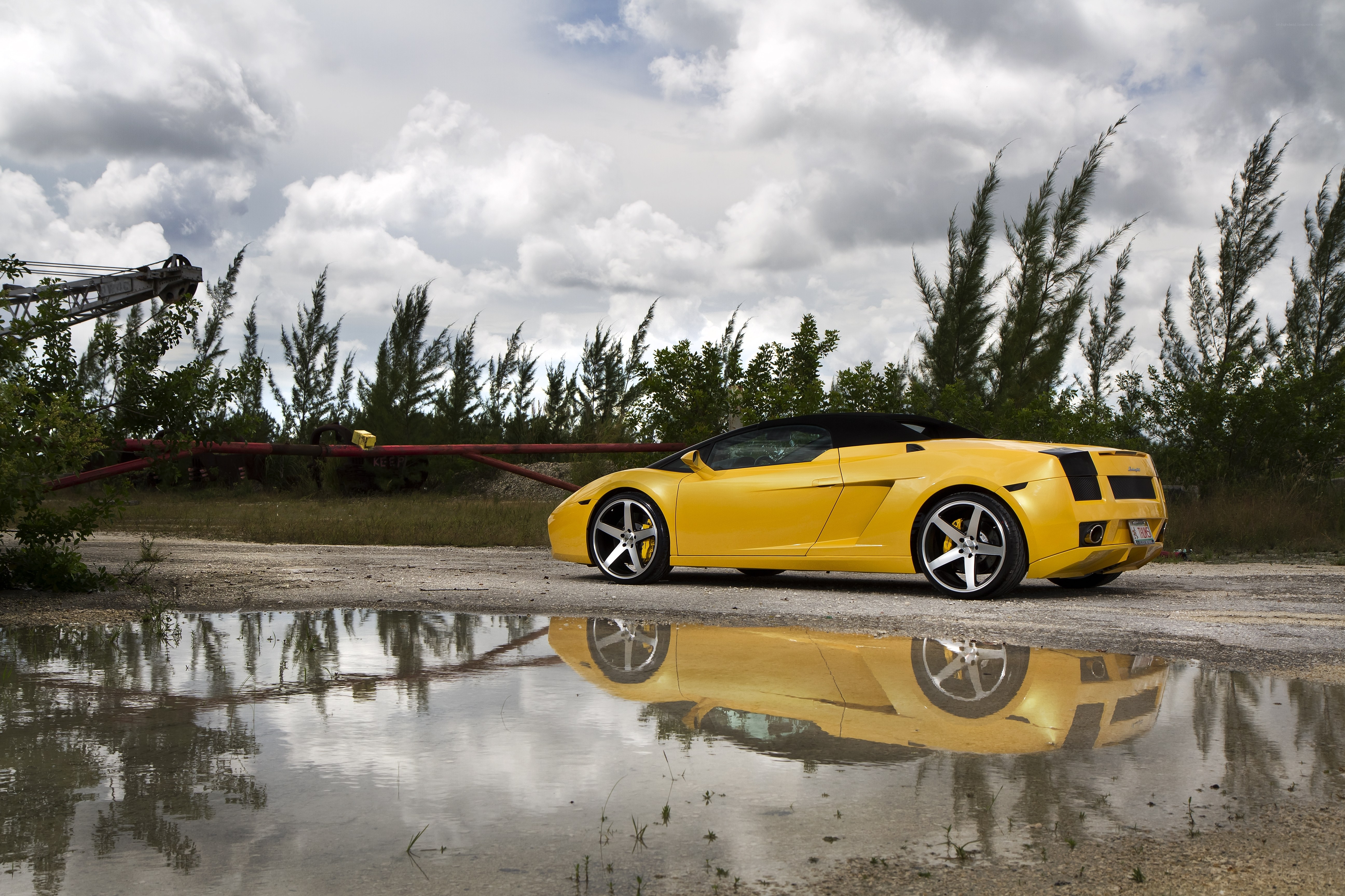 Yellow sports car in puddle