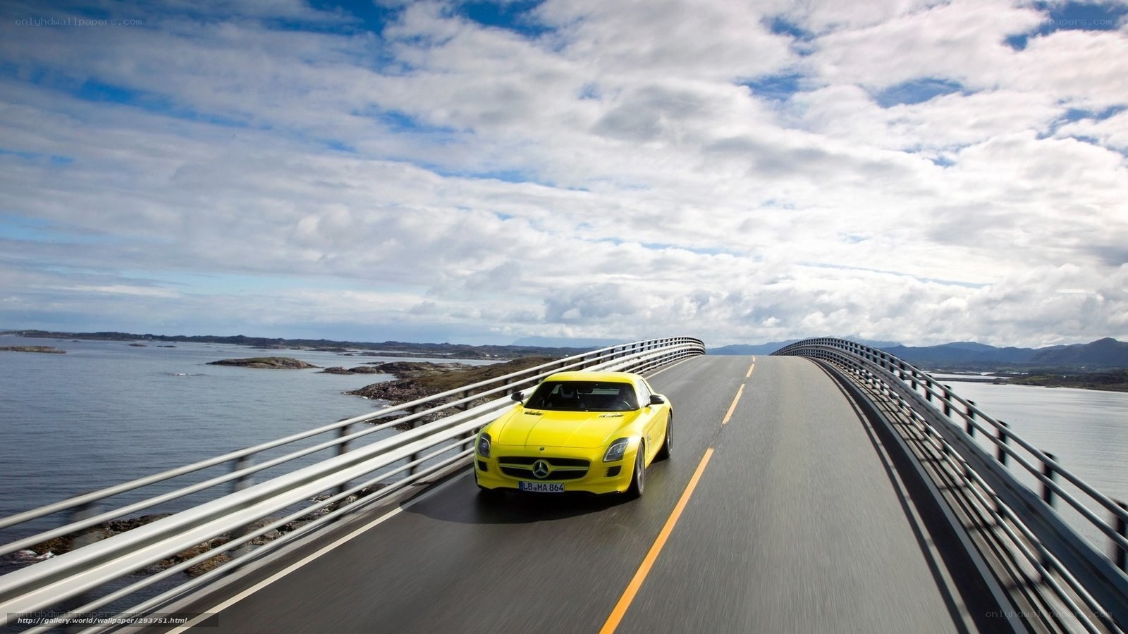 Yellow sports car on a coastal bridge
