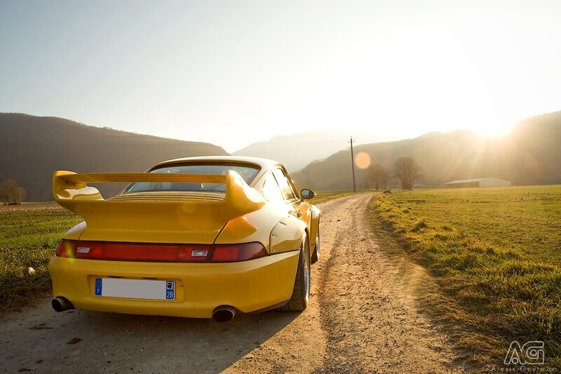 Yellow sports car on a country road