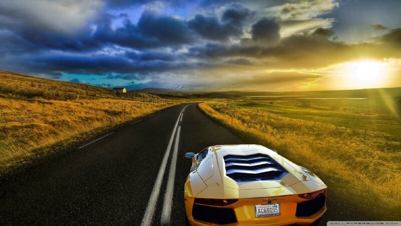 Yellow sports car on a country road