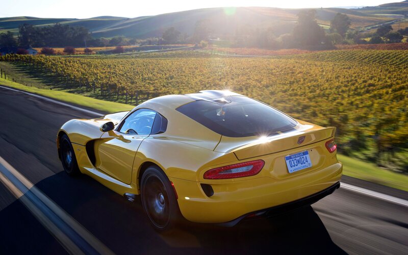 Yellow sports car on a country road
