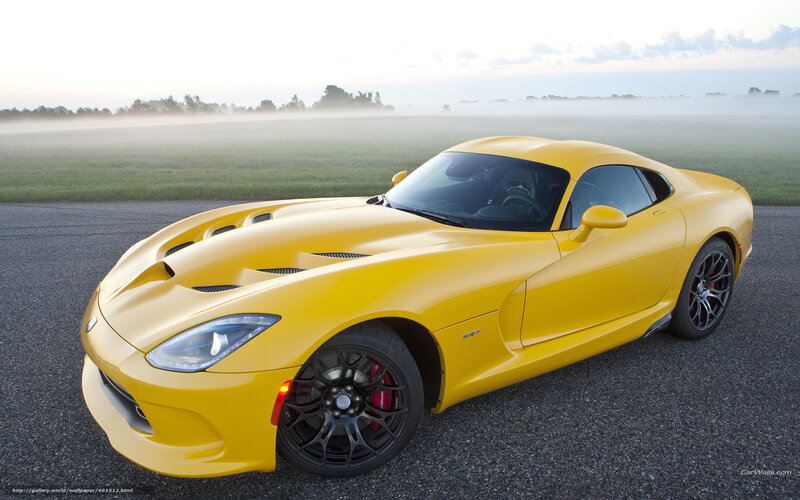 Yellow sports car on a foggy road