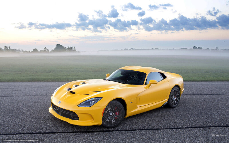 Yellow sports car on a foggy road