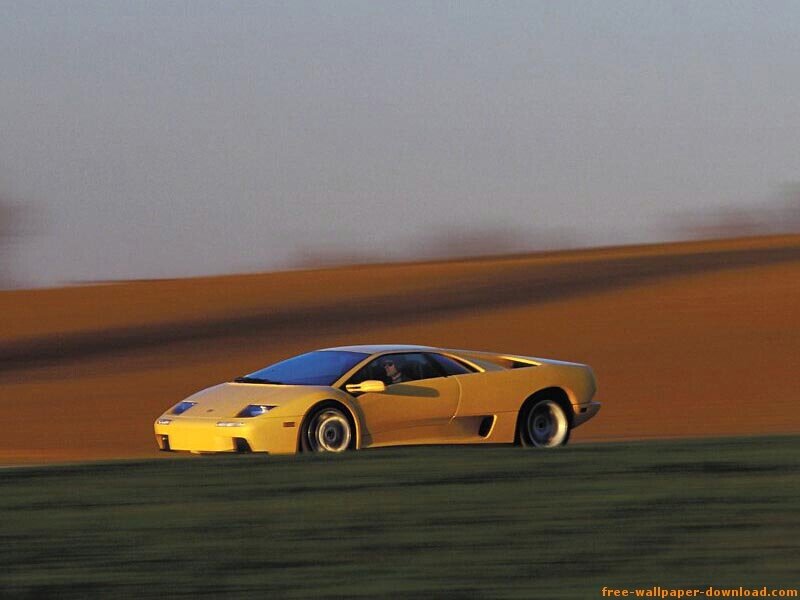 yellow sports car on a road