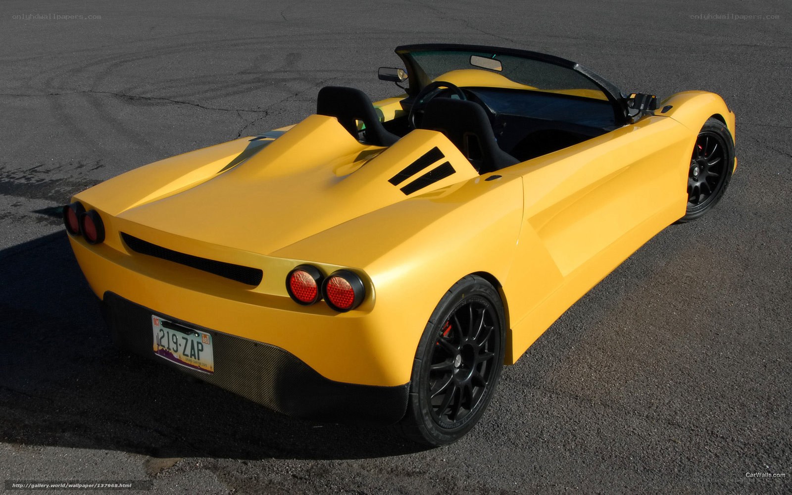 yellow sports car on asphalt