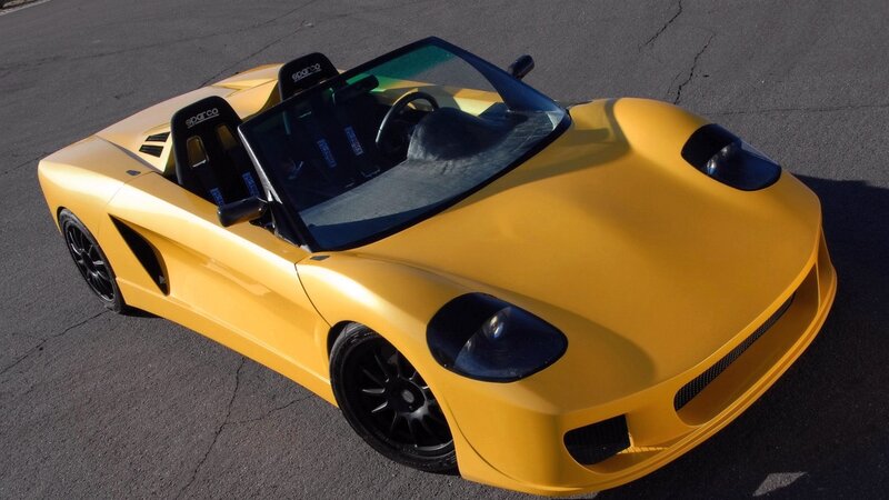 yellow sports car on asphalt