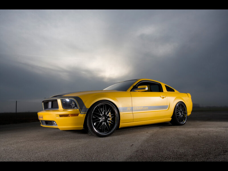 yellow sports car on asphalt