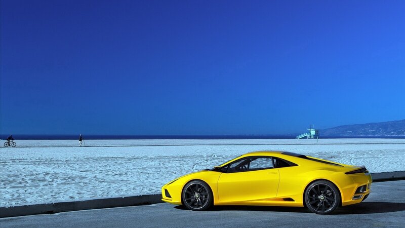 Yellow sports car on beach