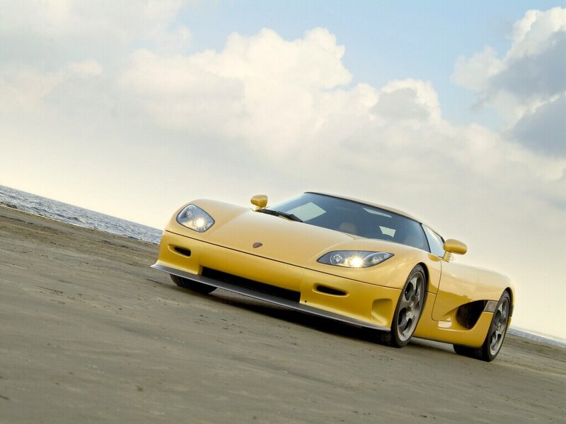 Yellow sports car on beach