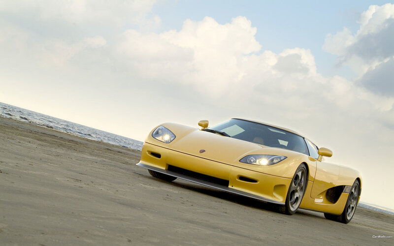 Yellow sports car on beach