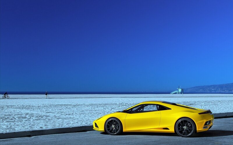 Yellow sports car on beach