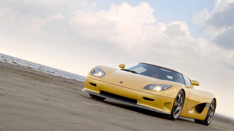 Yellow sports car on beach