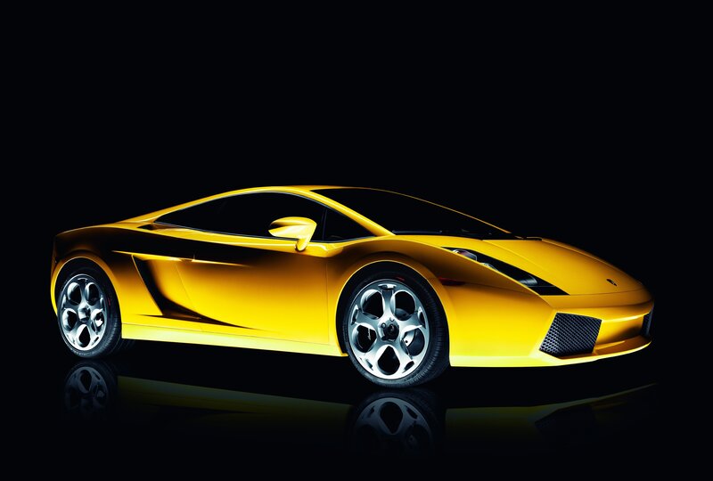 Yellow sports car on black background