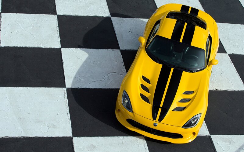 Yellow sports car on checkered floor