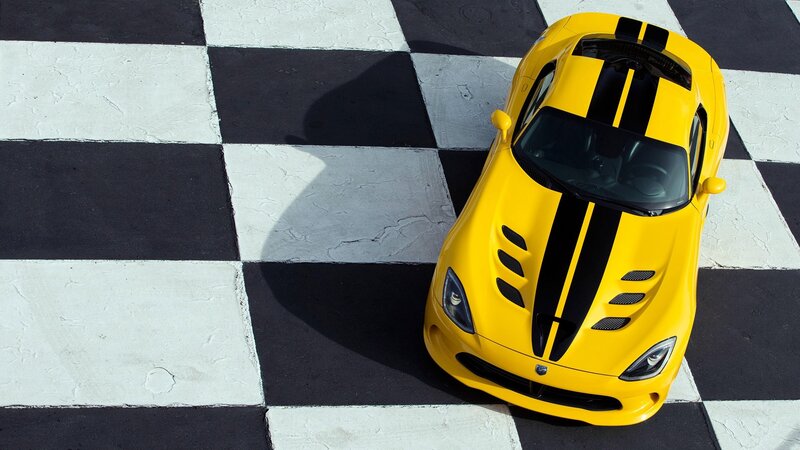 Yellow sports car on checkered floor