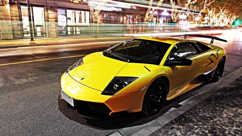yellow sports car on city street