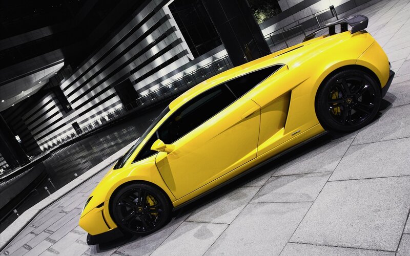 yellow sports car on city street