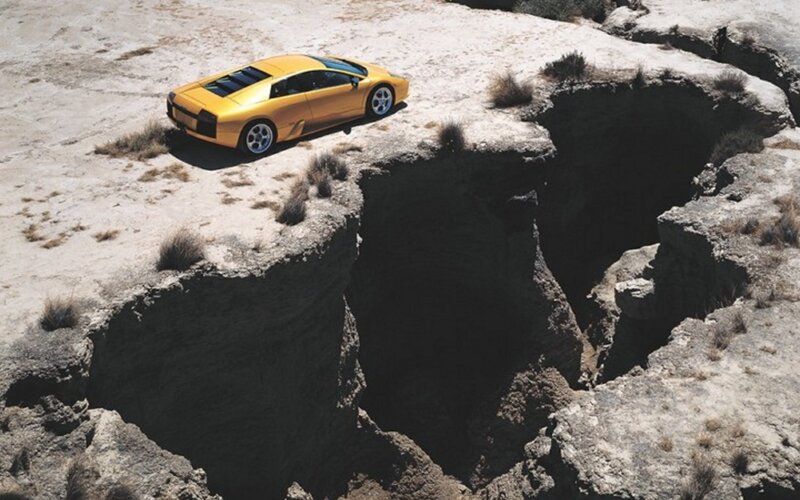 Yellow sports car on cliff edge