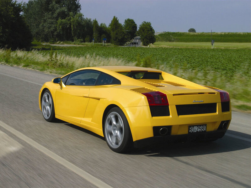 yellow sports car on country road
