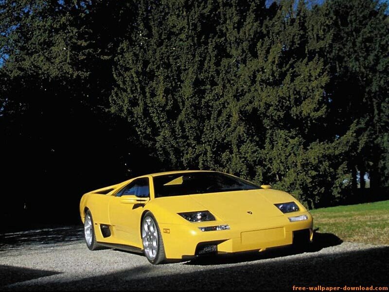 yellow sports car on gravel