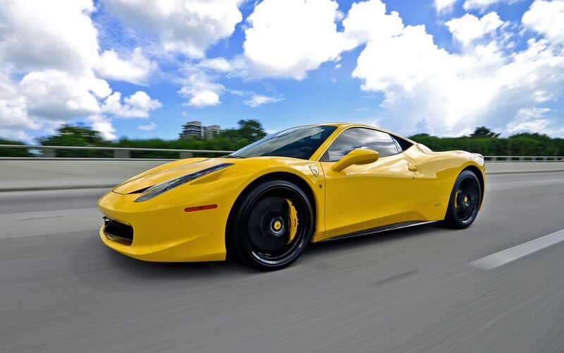yellow sports car on highway